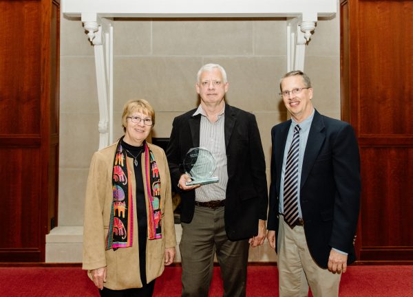Jerome Fast (center) stands with Dean Schmittmann (left) and Bill Gallus (right) after receiving the GEAT Distinguished Alumni Award